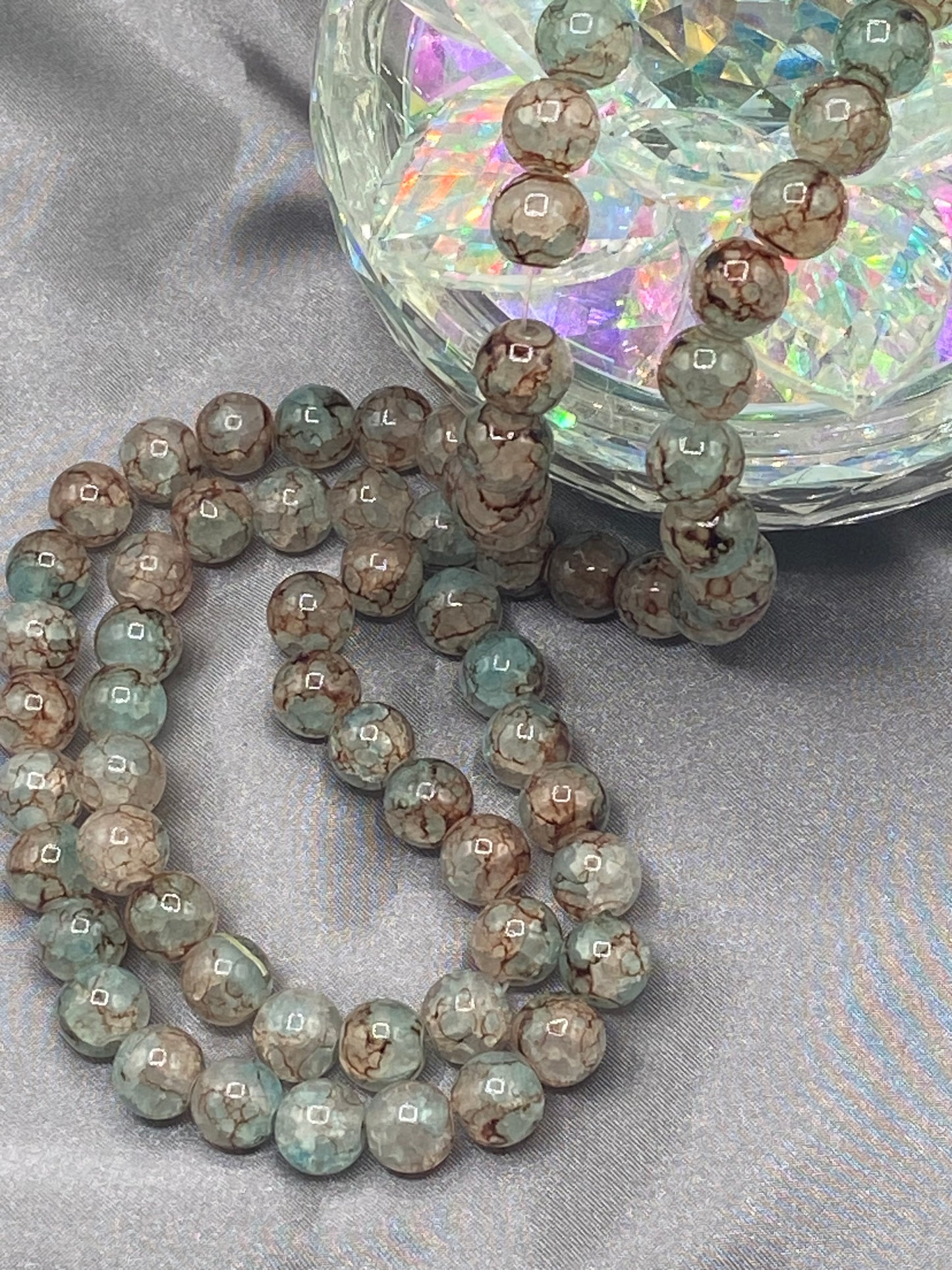 Glass bead 1 light teal and brown splatter colors